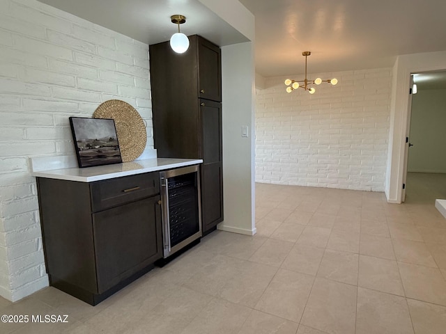 8324 E Beverly St, Tucson, AZ 85710 - bar area with beverage cooler, brick wall, a chandelier, pendant lighting, and light tile patterned flooring