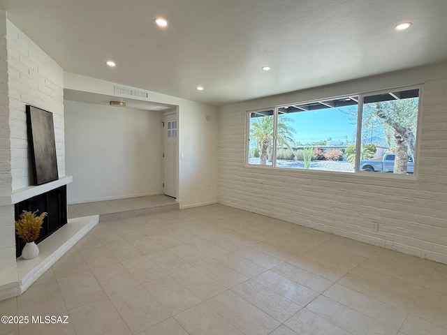 8324 E Beverly St, Tucson, AZ 85710 - unfurnished living room featuring recessed lighting, tile patterned floors, and a fireplace