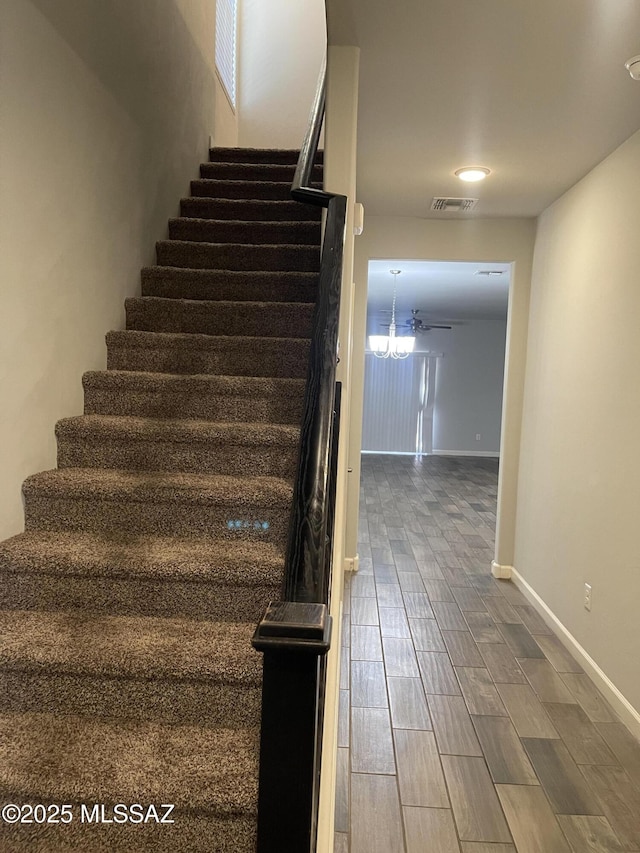 3306 N Baby Bruno Way, Tucson, AZ 85745 - staircase featuring baseboards and wood finished floors