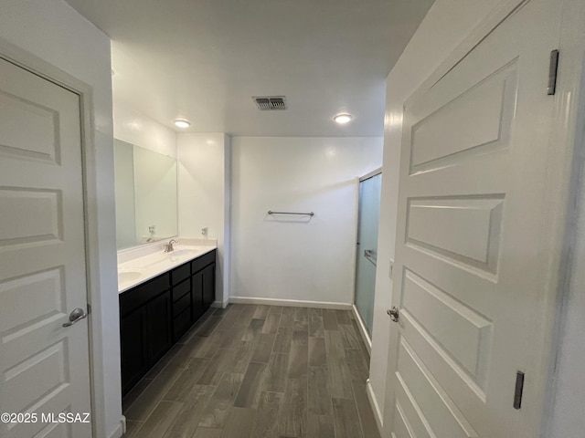 3306 N Baby Bruno Way, Tucson, AZ 85745 - bathroom featuring wood finished floors, double vanity, recessed lighting, and an enclosed shower