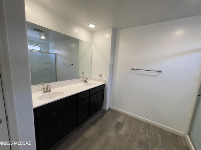 3306 N Baby Bruno Way, Tucson, AZ 85745 - full bathroom featuring wood finish floors, double vanity, and an enclosed shower
