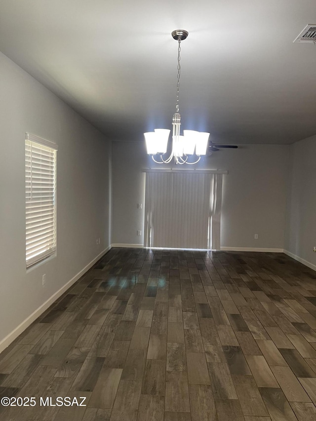 3306 N Baby Bruno Way, Tucson, AZ 85745 - empty room featuring a chandelier and dark wood-style floors