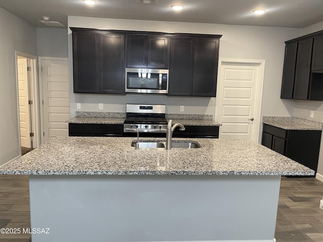 3306 N Baby Bruno Way, Tucson, AZ 85745 - kitchen with stainless steel appliances, light stone counters, dark wood finished floors, and recessed lighting