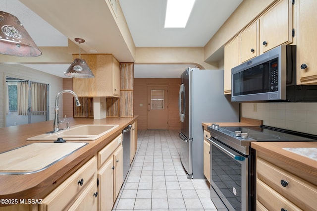 149 E La Huerta, Green Valley, AZ 85614 - kitchen with stainless steel appliances, wooden counters, light tile patterned floors, decorative backsplash, and light brown cabinets