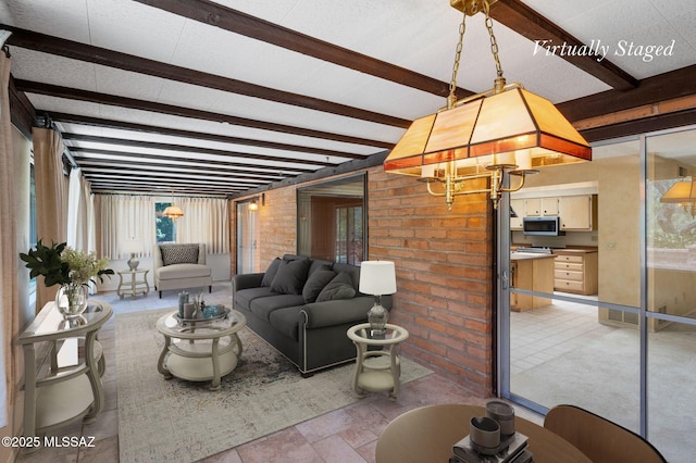 149 E La Huerta, Green Valley, AZ 85614 - living area featuring beam ceiling and brick wall