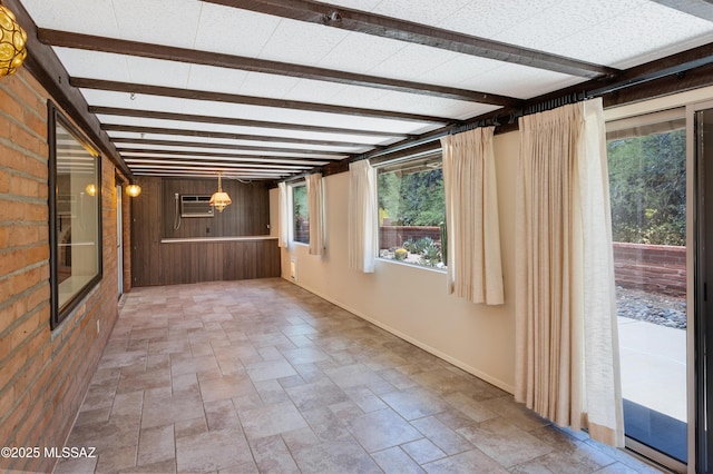 149 E La Huerta, Green Valley, AZ 85614 - unfurnished sunroom with healthy amount of natural light, beam ceiling, and a wall mounted AC