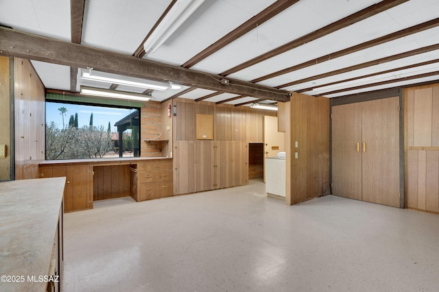 149 E La Huerta, Green Valley, AZ 85614 - unfurnished living room with wood walls, washer / dryer, and an office area