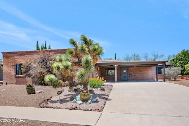149 E La Huerta, Green Valley, AZ 85614 - view of front of house with concrete driveway, a carport, and brick siding