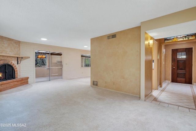 149 E La Huerta, Green Valley, AZ 85614 - unfurnished living room with carpet flooring, a brick fireplace, recessed lighting, and tile patterned floors