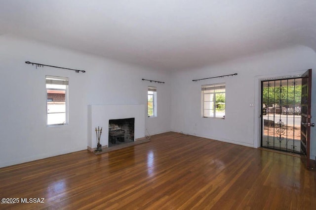 1816 E Waverly St, Tucson, AZ 85719 - unfurnished living room with wood finished floors and a fireplace