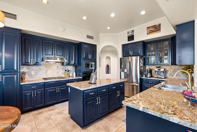 1511 E Placita Meseta Dorada, Oro Valley, AZ 85755 - kitchen with appliances with stainless steel finishes, blue cabinetry, arched walkways, a center island, and recessed lighting