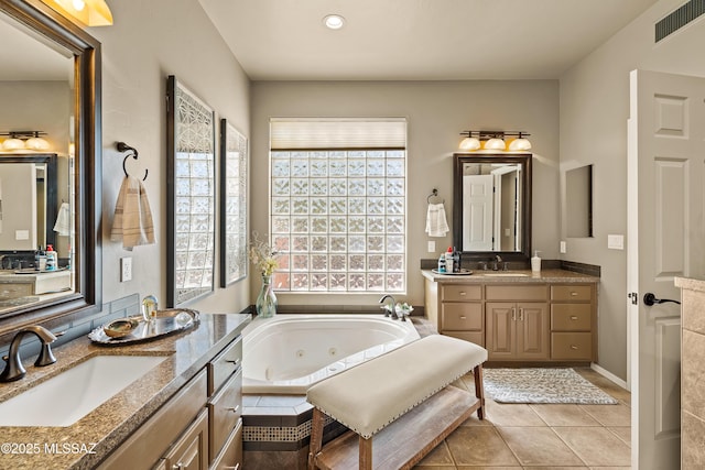 1511 E Placita Meseta Dorada, Oro Valley, AZ 85755 - full bathroom featuring plenty of natural light, a tub with jets, two vanities, tile patterned flooring, and recessed lighting