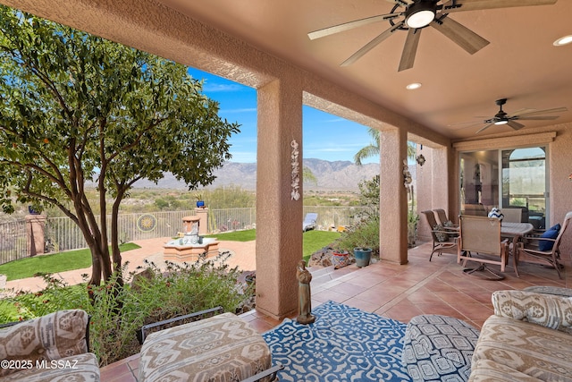 1511 E Placita Meseta Dorada, Oro Valley, AZ 85755 - fenced backyard featuring a ceiling fan, a mountain view, a patio, and outdoor dining area