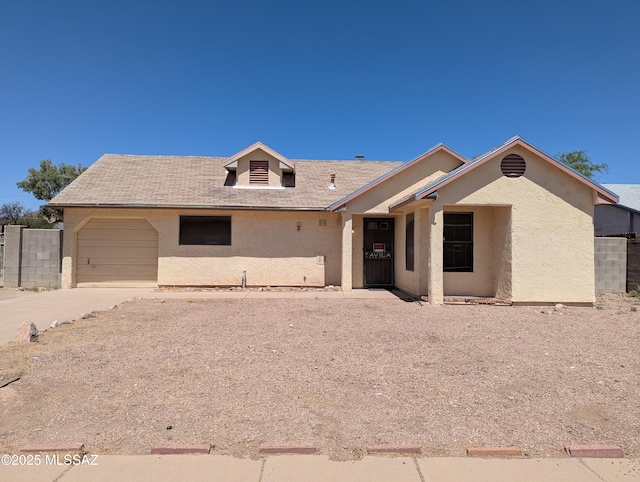 7088 S Camino Grande, Tucson, AZ 85746 - view of front of home featuring an attached garage, driveway, and stucco siding