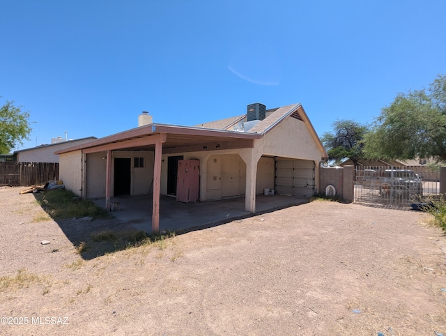 7088 S Camino Grande, Tucson, AZ 85746 - view of property exterior featuring a chimney, stucco siding, and a garage