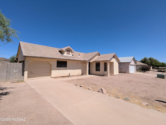 7088 S Camino Grande, Tucson, AZ 85746 - ranch-style house featuring an attached garage, stucco siding, and driveway