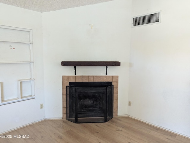 7088 S Camino Grande, Tucson, AZ 85746 - detailed view of wood finished floors and a tiled fireplace