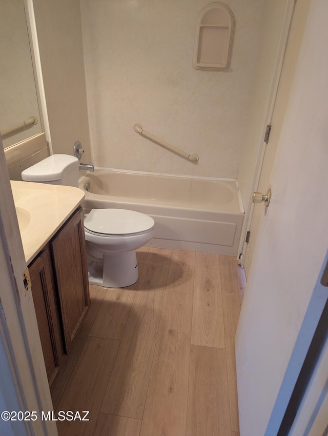 7088 S Camino Grande, Tucson, AZ 85746 - full bathroom featuring vanity, wood finished floors, and washtub / shower combination