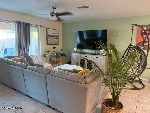 9150 N Wagon Spoke Ct, Tucson, AZ 85742 - living room featuring light tile patterned flooring and a ceiling fan