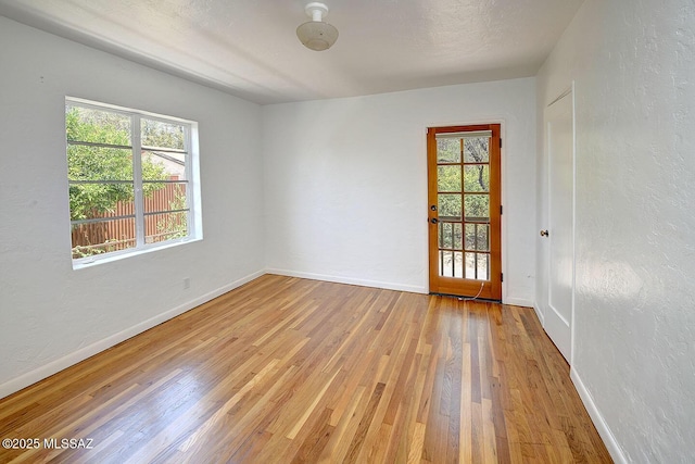 2421 E Drachman St, Tucson, AZ 85719 - empty room featuring wood finished floors and a textured wall