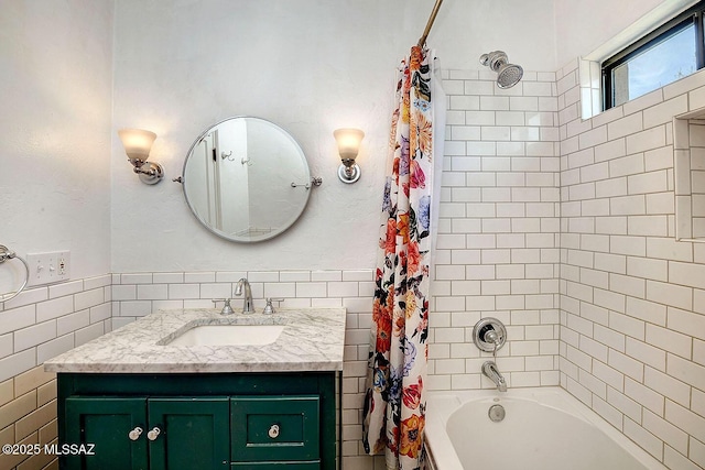 2421 E Drachman St, Tucson, AZ 85719 - bathroom featuring shower / bath combo, vanity, and tile walls