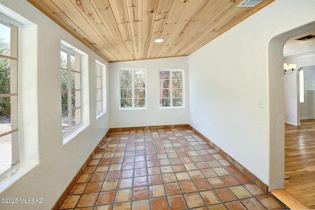 2421 E Drachman St, Tucson, AZ 85719 - unfurnished sunroom featuring arched walkways, lofted ceiling, and a chandelier