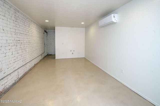 2421 E Drachman St, Tucson, AZ 85719 - below grade area featuring a wall mounted air conditioner, recessed lighting, and brick wall