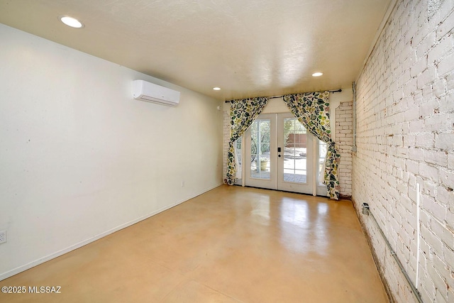 2421 E Drachman St, Tucson, AZ 85719 - unfurnished room featuring a wall mounted air conditioner, french doors, recessed lighting, and finished concrete flooring