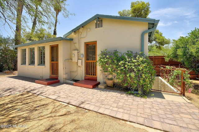 2421 E Drachman St, Tucson, AZ 85719 - view of front of house featuring stucco siding and a gate
