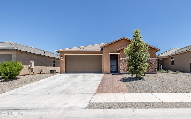 8820 E Stone Meadow Cir, Tucson, AZ 85730 - single story home featuring stucco siding, an attached garage, driveway, a tile roof, and stone siding