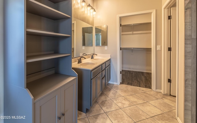 8820 E Stone Meadow Cir, Tucson, AZ 85730 - bathroom featuring double vanity, tile patterned flooring, and a walk in closet