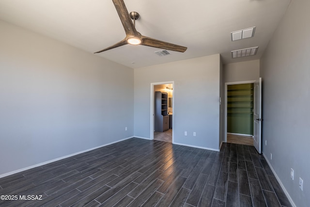 8820 E Stone Meadow Cir, Tucson, AZ 85730 - unfurnished bedroom featuring dark wood finished floors and a ceiling fan