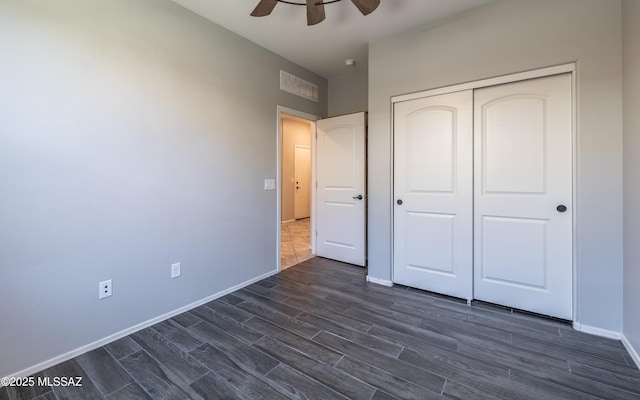8820 E Stone Meadow Cir, Tucson, AZ 85730 - unfurnished bedroom featuring dark wood-style flooring, a closet, and ceiling fan