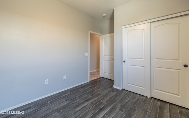 8820 E Stone Meadow Cir, Tucson, AZ 85730 - unfurnished bedroom with dark wood-style floors and a closet