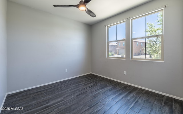 8820 E Stone Meadow Cir, Tucson, AZ 85730 - empty room with healthy amount of natural light, dark wood-type flooring, and a ceiling fan