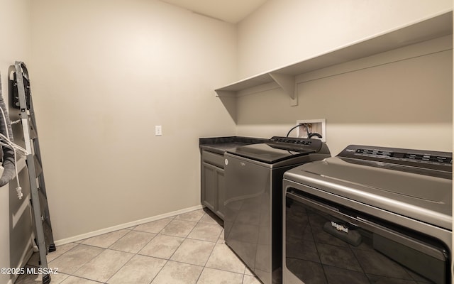 8820 E Stone Meadow Cir, Tucson, AZ 85730 - laundry area with cabinet space, washing machine and clothes dryer, and light tile patterned floors