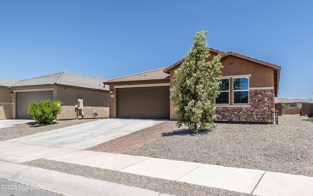 8820 E Stone Meadow Cir, Tucson, AZ 85730 - ranch-style house with an attached garage, concrete driveway, a tile roof, stucco siding, and stone siding