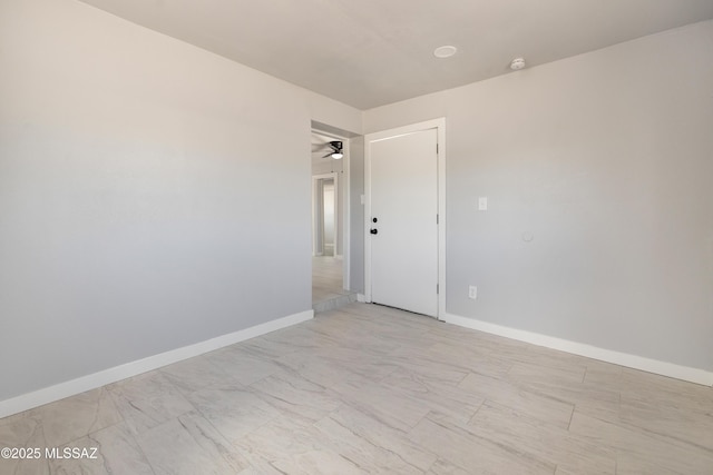 5609 E Juarez St, Tucson, AZ 85711 - empty room featuring a ceiling fan, light marble finish floors, and a smoke detector