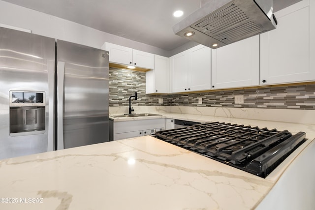 5609 E Juarez St, Tucson, AZ 85711 - kitchen with stainless steel fridge, exhaust hood, stovetop, and decorative backsplash