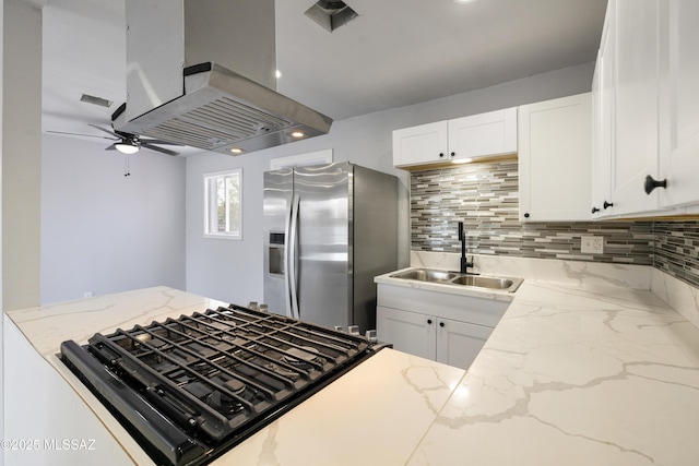 5609 E Juarez St, Tucson, AZ 85711 - kitchen featuring stainless steel fridge with ice dispenser, island range hood, ceiling fan, backsplash, and white cabinets