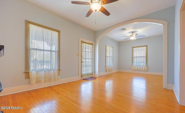 201 B St, Bisbee, AZ 85603 - spare room featuring arched walkways, ceiling fan, and light wood-style flooring
