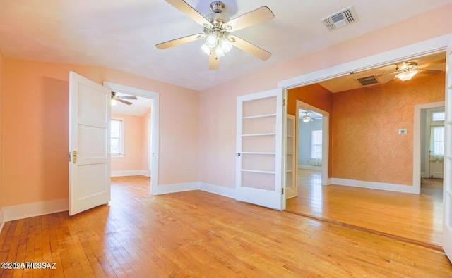 201 B St, Bisbee, AZ 85603 - empty room with ceiling fan, light wood-style floors, and built in shelves