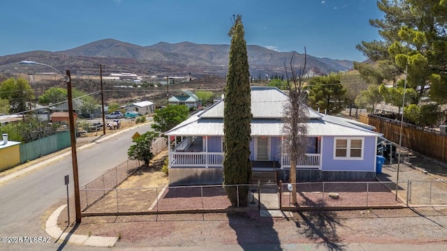 201 B St, Bisbee, AZ 85603 - view of front facade featuring a fenced front yard, a mountain view, and covered porch