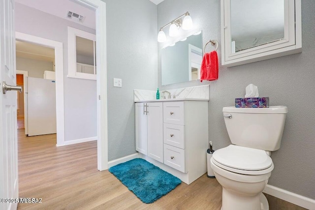 201 B St, Bisbee, AZ 85603 - bathroom with wood finished floors, vanity, and a textured wall