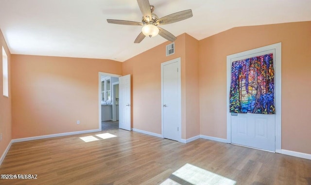 201 B St, Bisbee, AZ 85603 - unfurnished bedroom with vaulted ceiling, wood finished floors, and ceiling fan