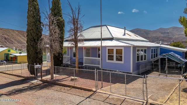 201 B St, Bisbee, AZ 85603 - view of front of house featuring a porch, a fenced front yard, a mountain view, and a gate