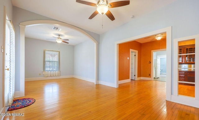 201 B St, Bisbee, AZ 85603 - unfurnished room with ceiling fan, arched walkways, and light wood-type flooring