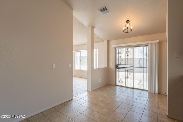 3556 W Avenida Del Mar, Tucson, AZ 85746 - empty room featuring light tile patterned floors and vaulted ceiling