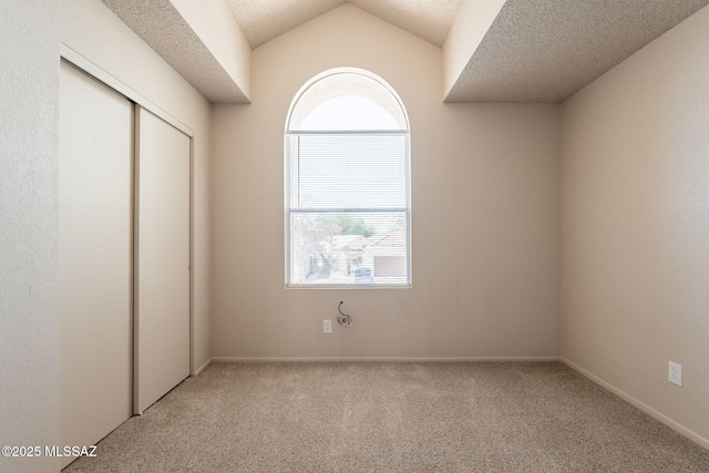 3556 W Avenida Del Mar, Tucson, AZ 85746 - unfurnished bedroom featuring carpet flooring, a closet, a textured ceiling, and lofted ceiling