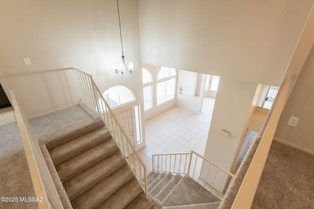 3556 W Avenida Del Mar, Tucson, AZ 85746 - staircase featuring carpet floors, a chandelier, and a high ceiling
